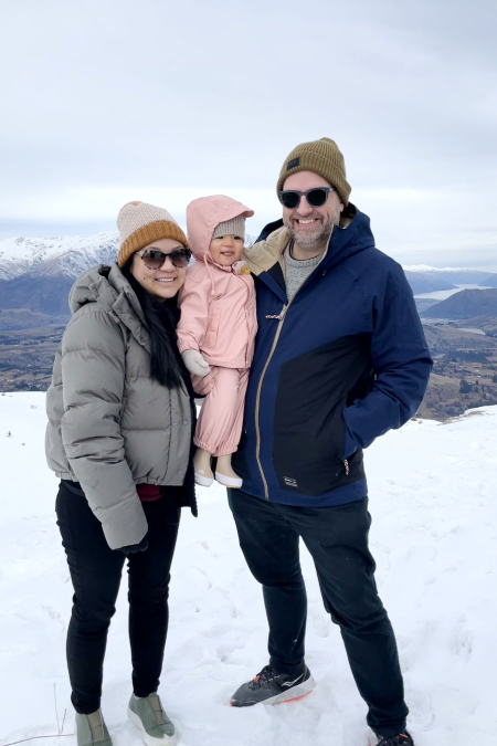 Family on snowy mountain with baby girl