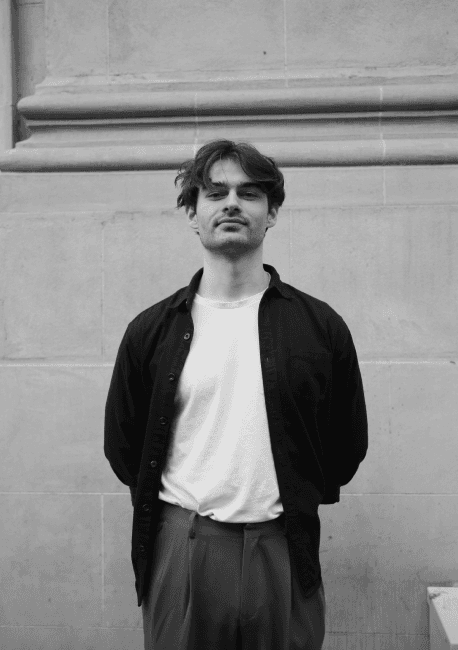 Connor standing in front of brick wall