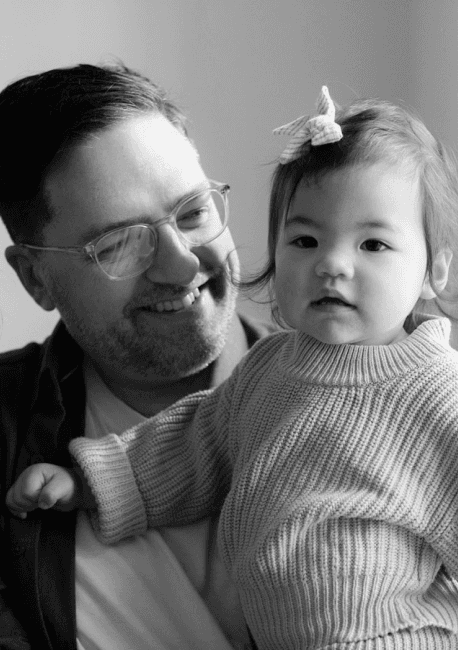 Dave sitting with daughter standing on his lap